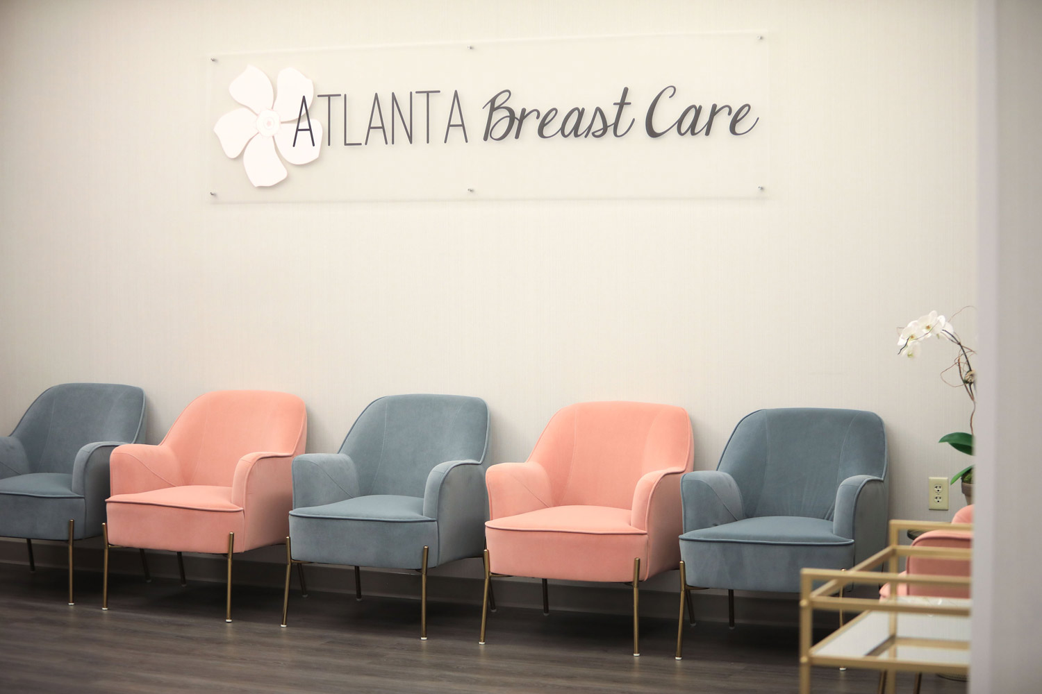 Interior office for Atlanta Breast Care showing seating and logo on wall